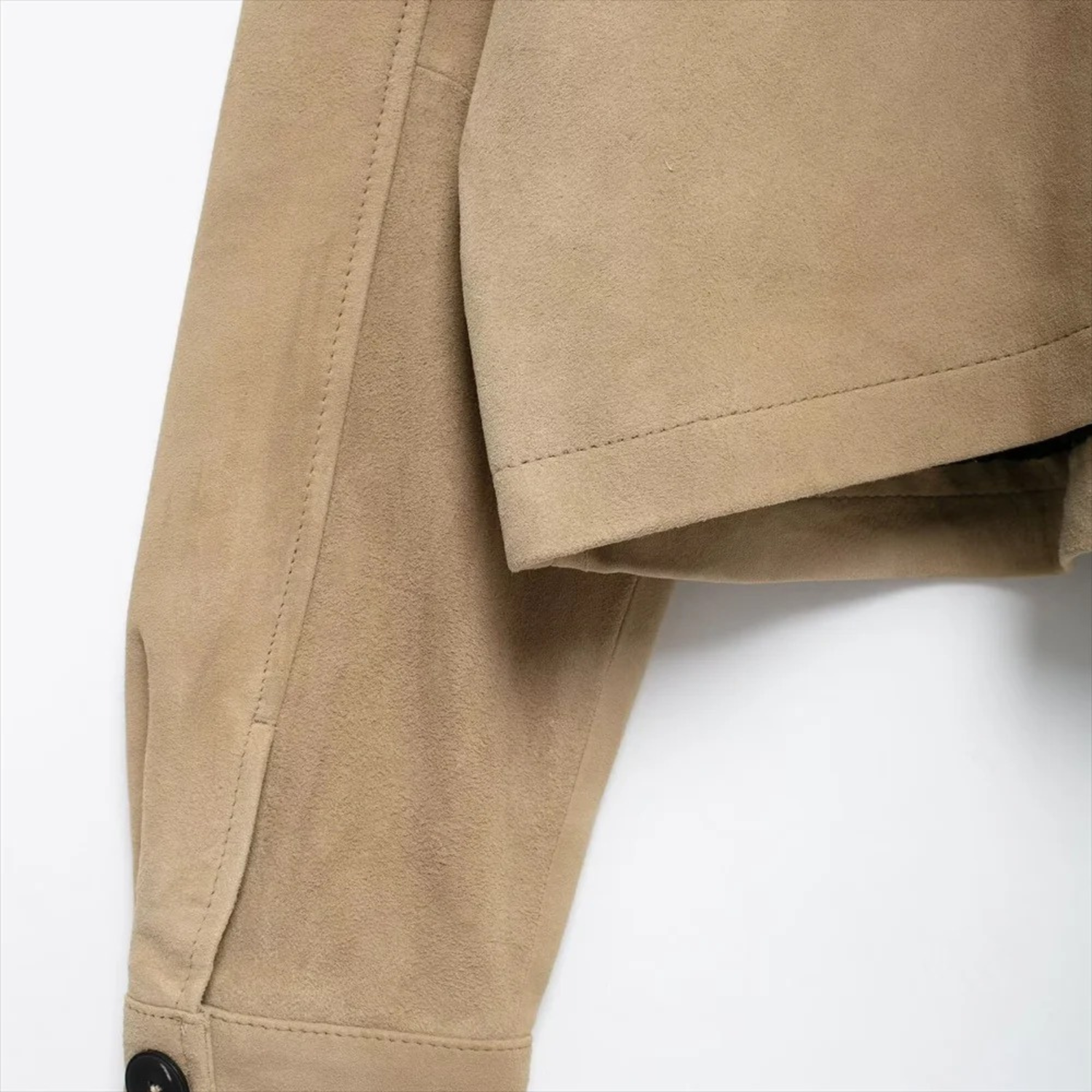 Tan suede jacket sleeve.