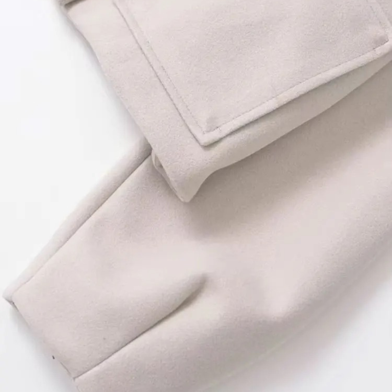 Beige fabric with pocket detail.