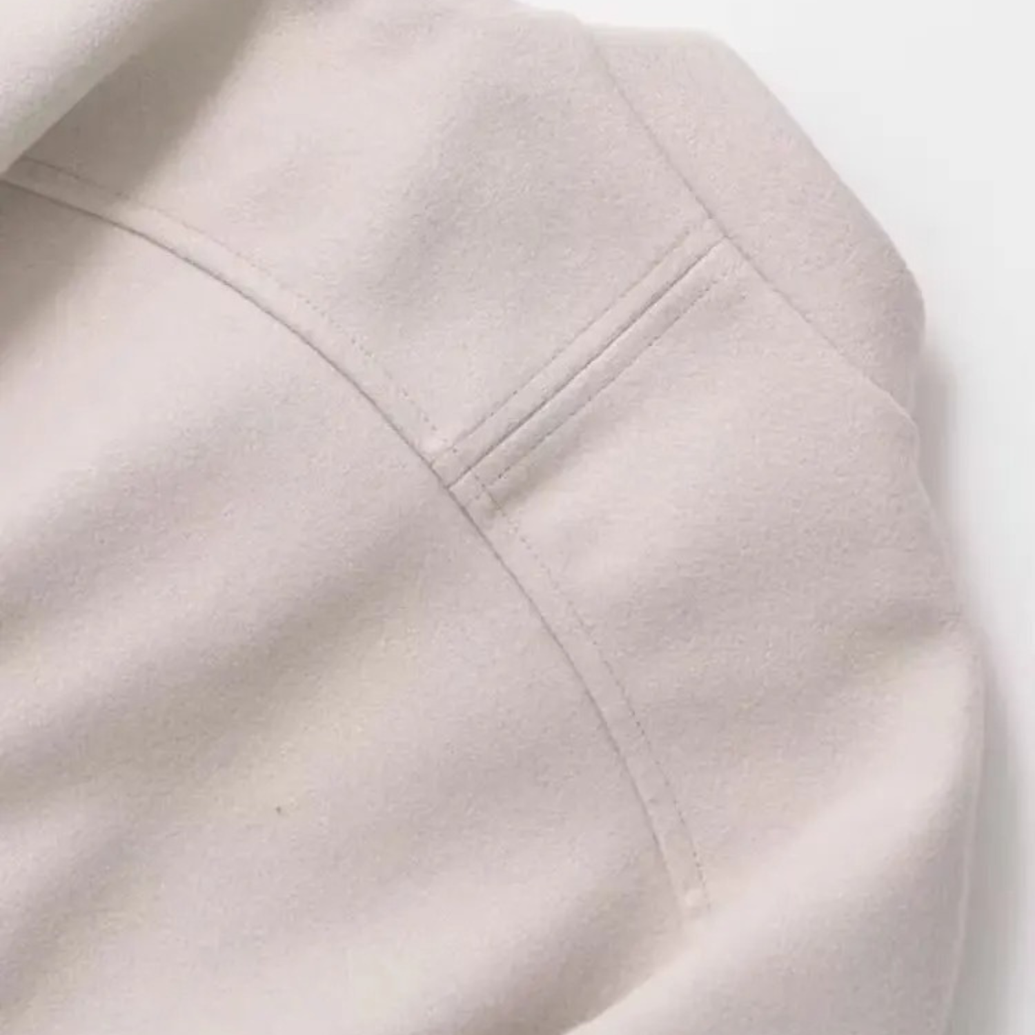 Beige jacket shoulder detail.