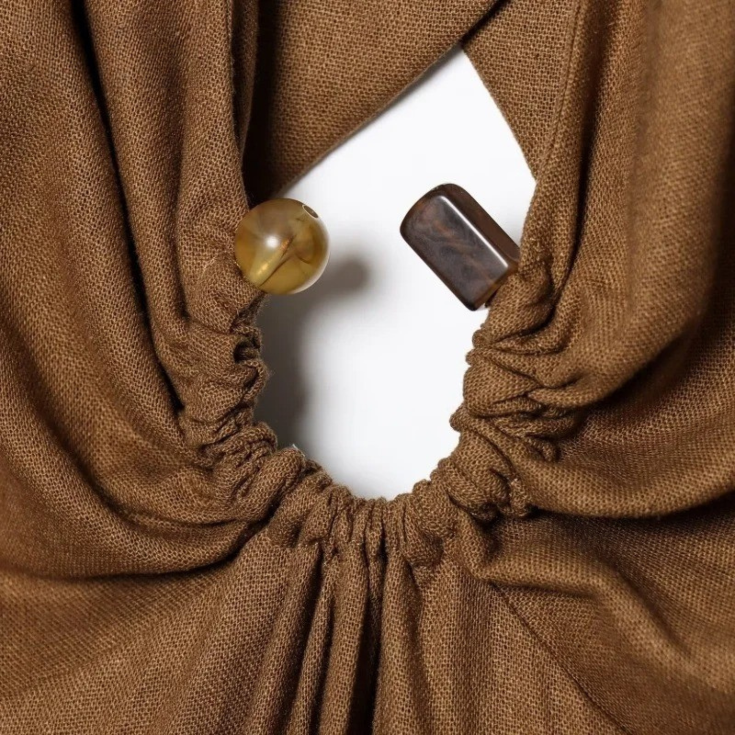Brown fabric top with decorative closures.