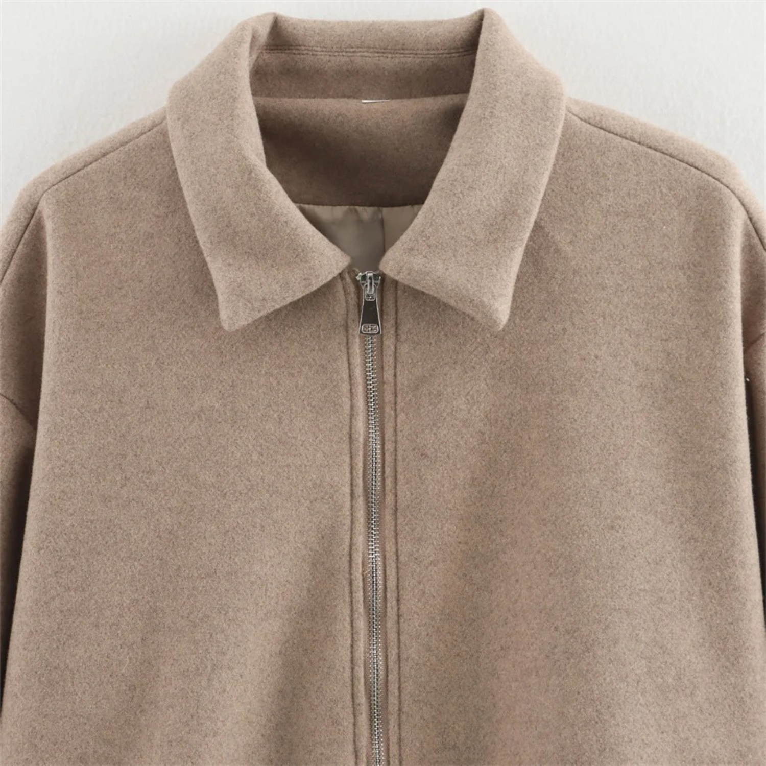 Beige zip-up jacket.