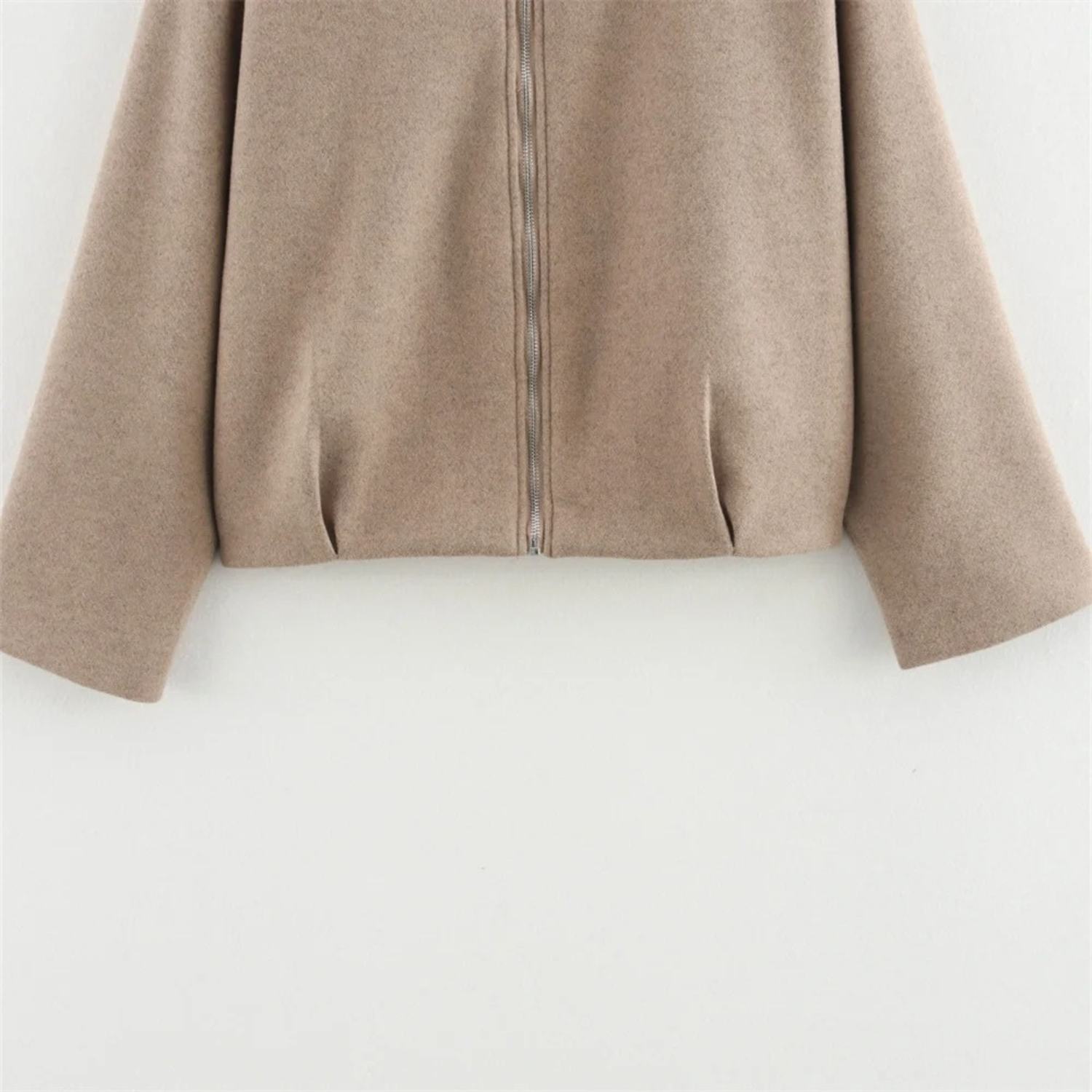 Beige zip-up jacket.