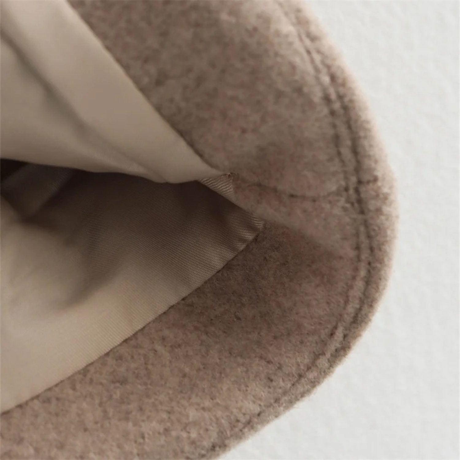 Beige wool-blend fabric with lining.