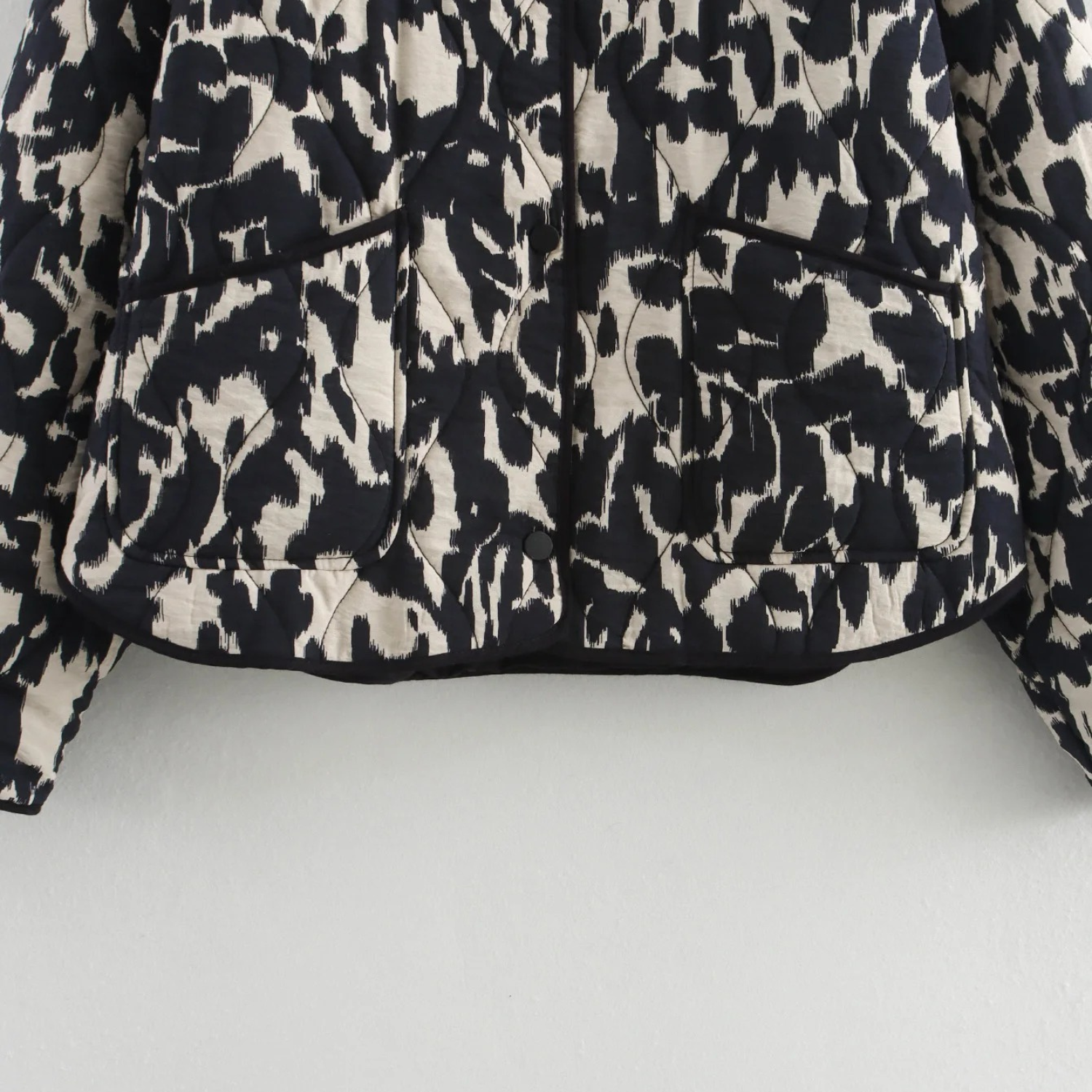 Black and white patterned quilted jacket.