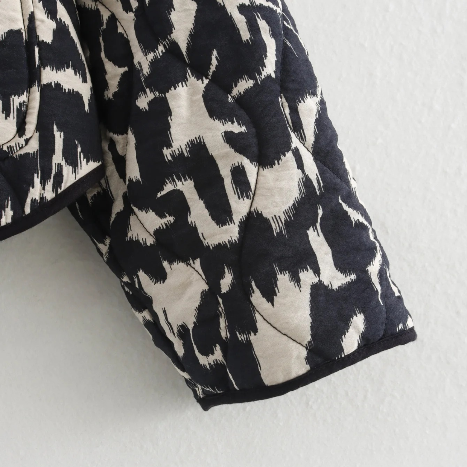 Black and white patterned quilted jacket.