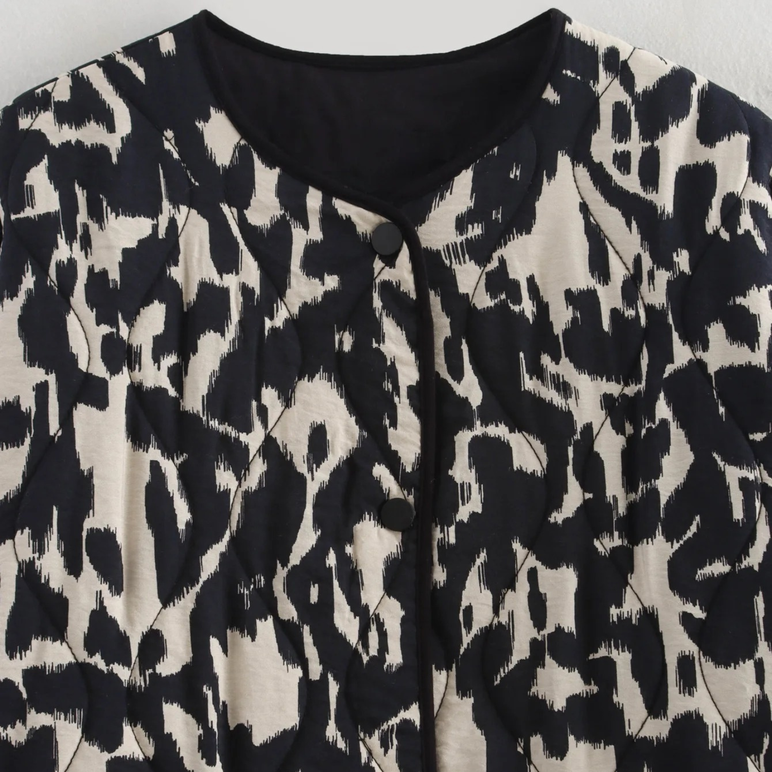 Black and white patterned blouse.