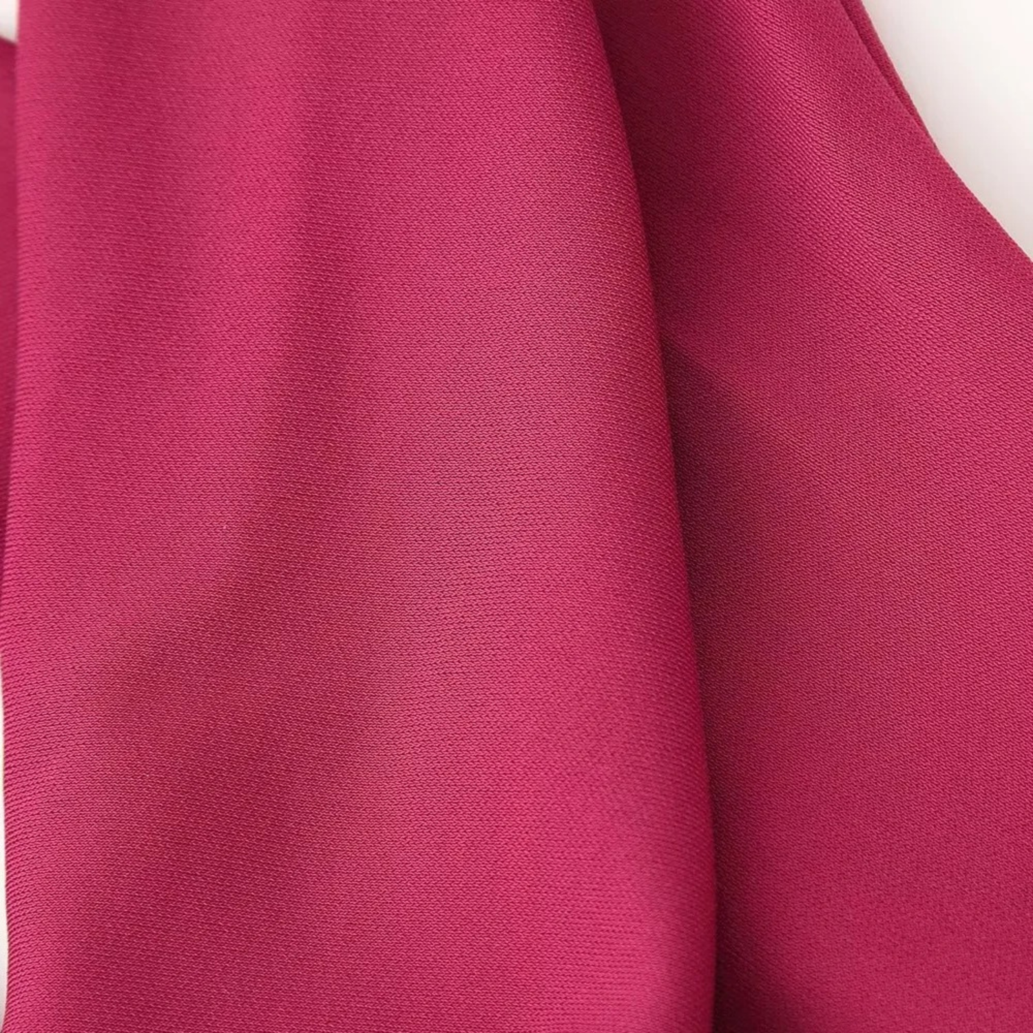 Crumpled magenta fabric.