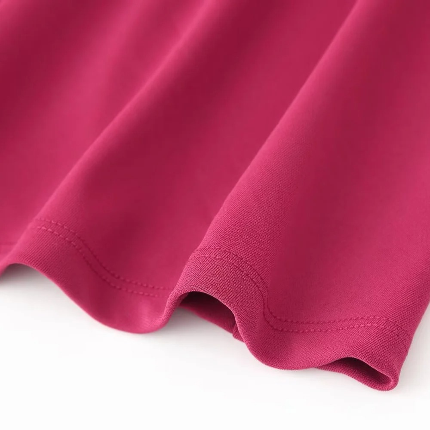 Crimson fabric with hemmed edge.