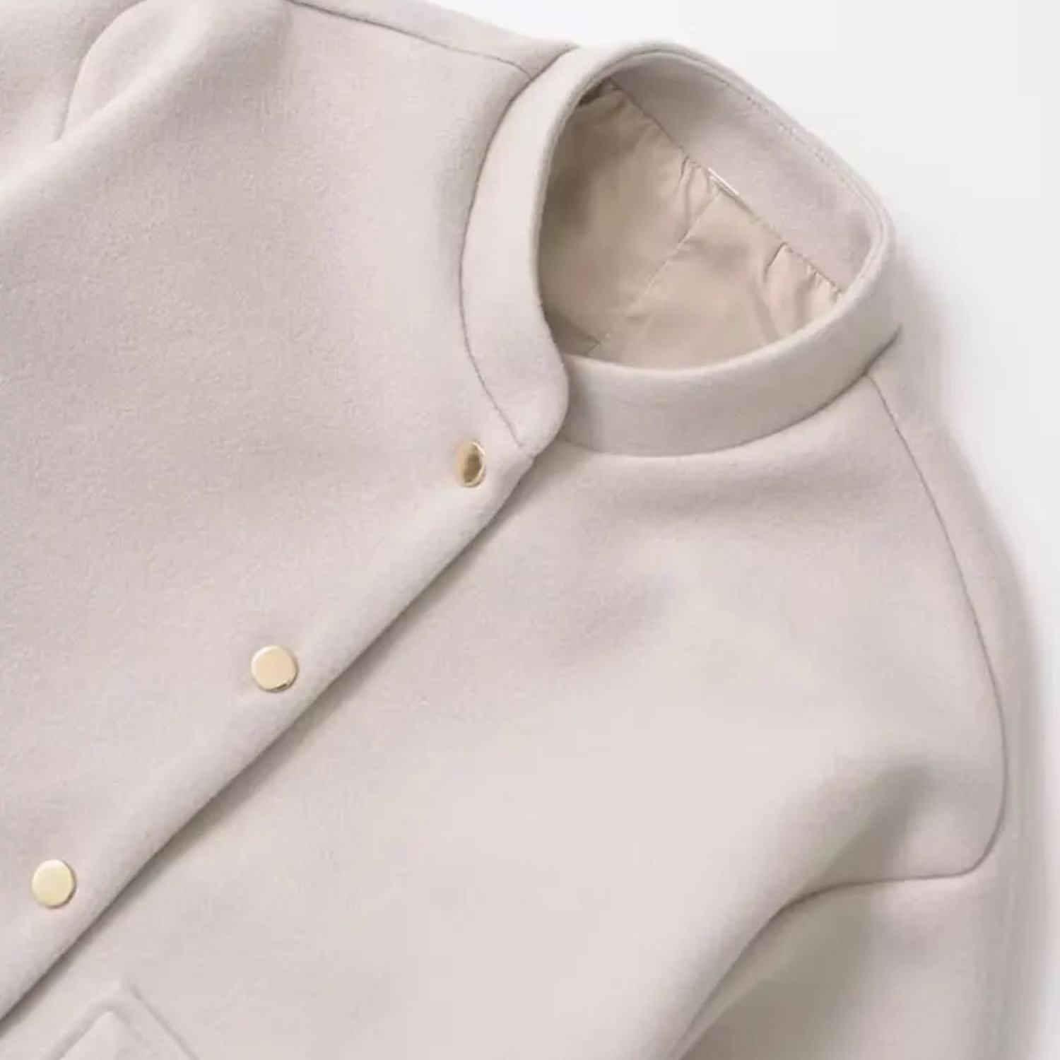 Beige collar jacket with gold buttons.