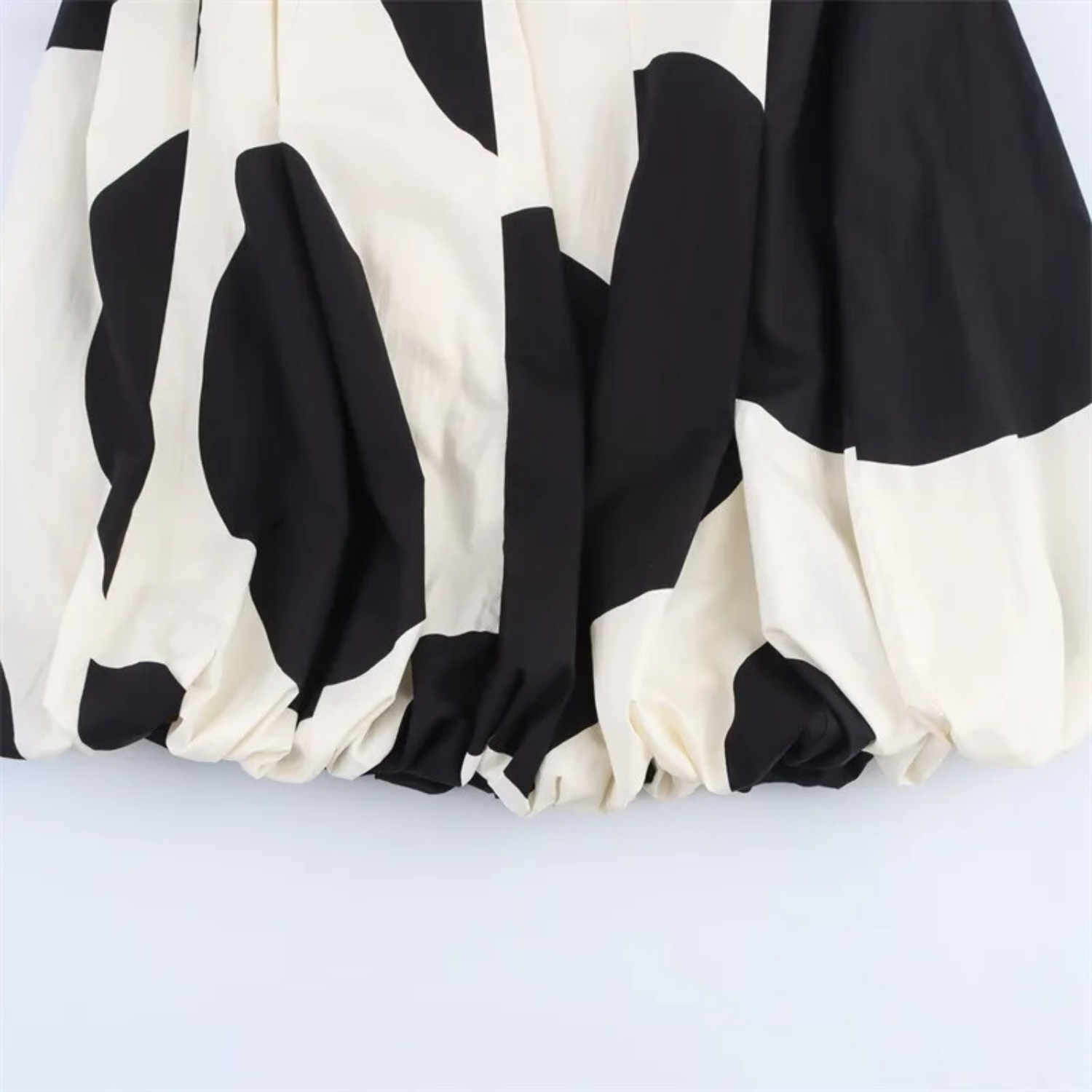 Black and white patterned balloon skirt.